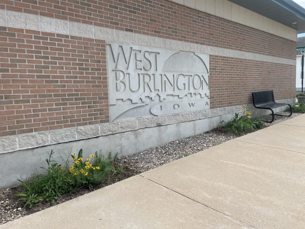 West Burlington, Iowa city signage with skyline detail