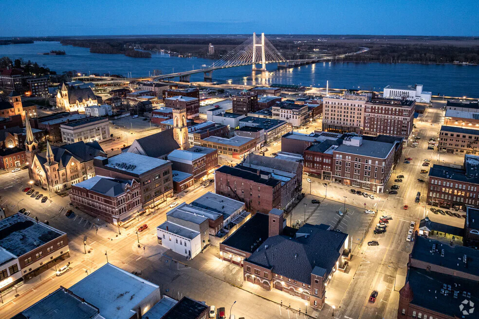 Aerial view of downtown Burlington, Iowa at dusk with the Great River Bridge in the background